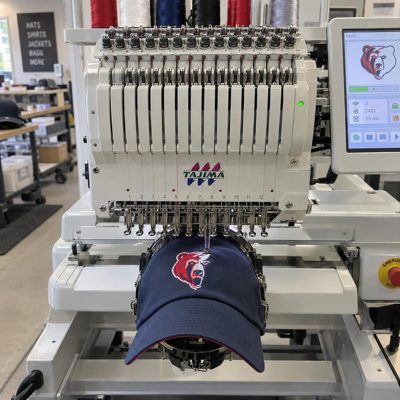 A cap mounted on an embroidery machine cap frame